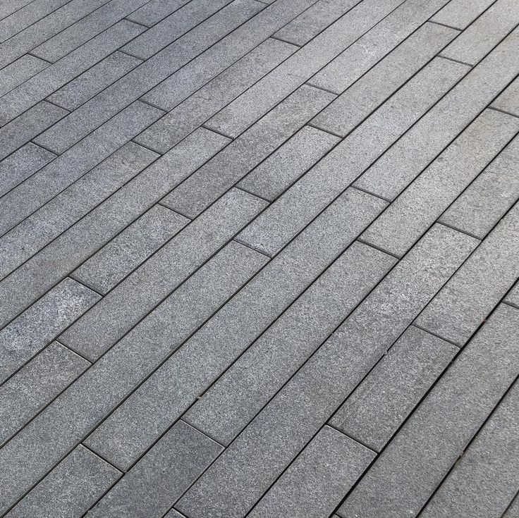 Black Granite Planks – sleek and narrow-format paving for a contemporary outdoor finish.
